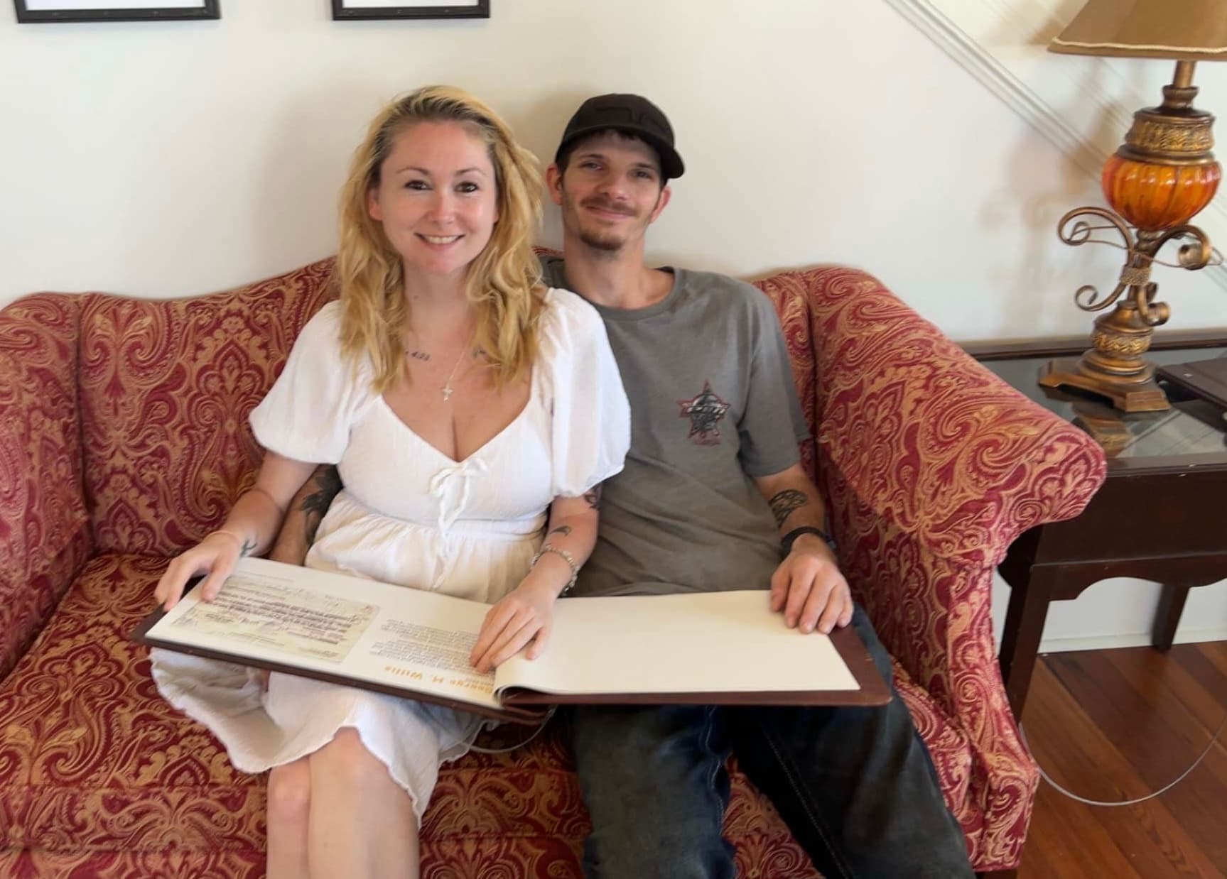 A real couple quietly looking through documents together reads as a genuine, low-key moment of partnership under weight, which suits the article's honest tone about navigating hard benefit conversations as a couple.